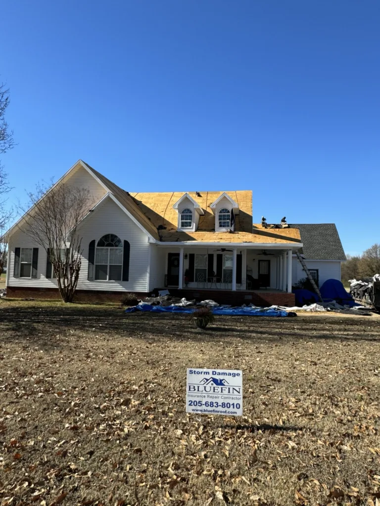 Roof tear-off and decking repairs around two dormers during a hail damage roof replacement in Stewart, Alabama