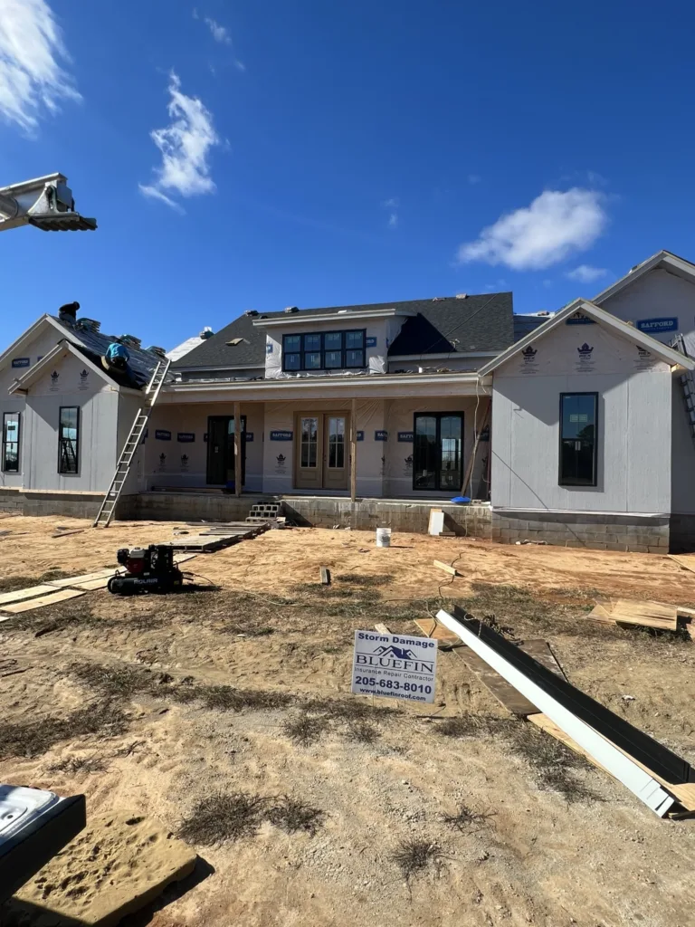 Custom home shingles and a metal porch roof by Bluefin Exteriors in Greensboro, Alabama